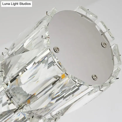 Modern silver crystal tube island light featuring faceted clear glass elements and sleek metal base for dining room use
