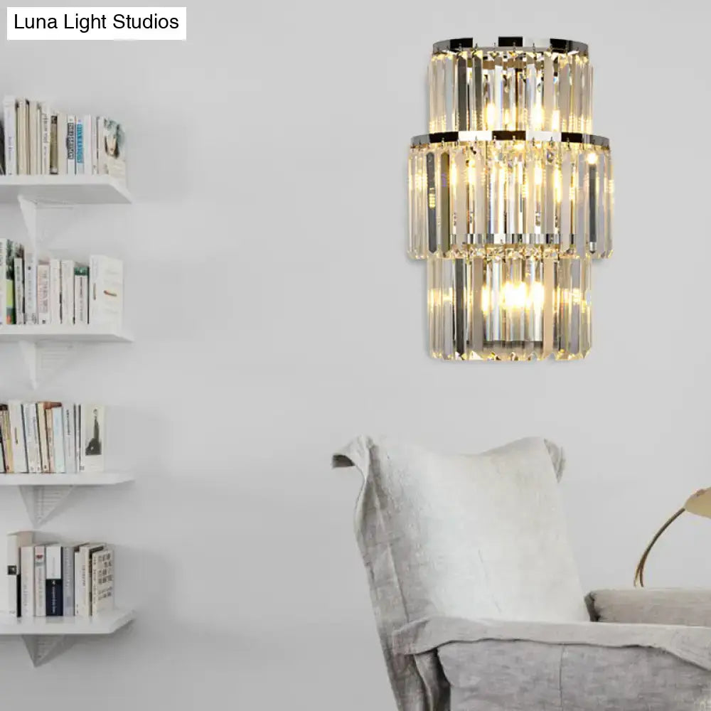 Modern silver crystal wall mounted light featuring tiered clear faceted glass bands and polished chrome accents for living room