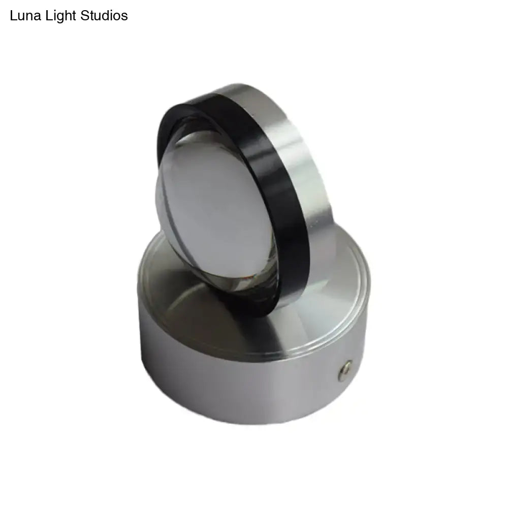 Silver finish cylindrical wall-mounted light fixture with polished metallic finish and black accent ring for bedroom wall warm white lighting