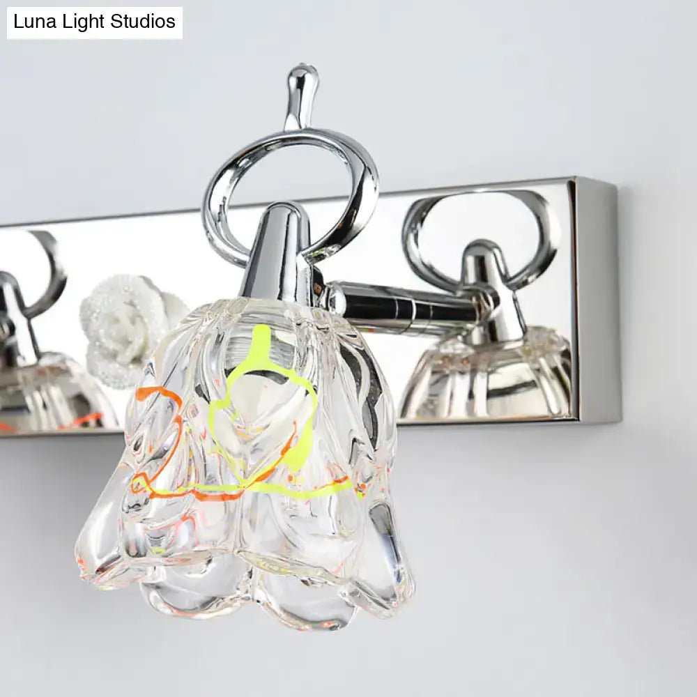 Modern silver finish wall light with clear glass bell-shaped lampshade and yellow orange internal wire accents