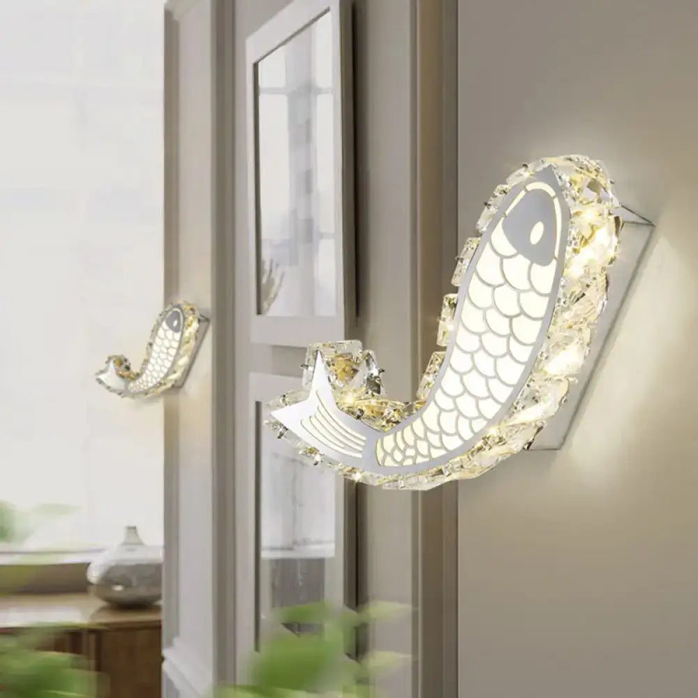 Modern silver fish wall sconce with crystal block shade and silver metallic body for bedroom lighting