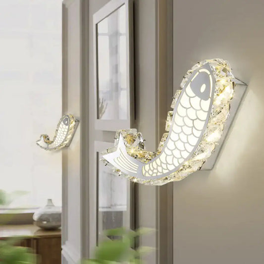 Modern silver fish wall sconce with crystal block shade and silver metallic body for bedroom lighting