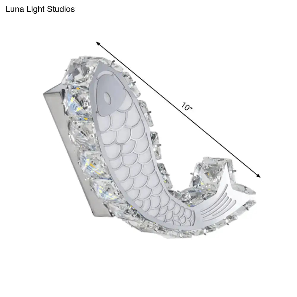 Modern silver fish wall sconce with crystal block shade, polished chrome base, and intricate scale detailing for bedroom light