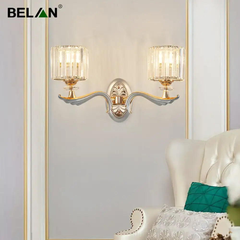 Modern gold-toned flush mount wall light with silver accents and two clear crystal shade bulb base fixtures for bedroom use