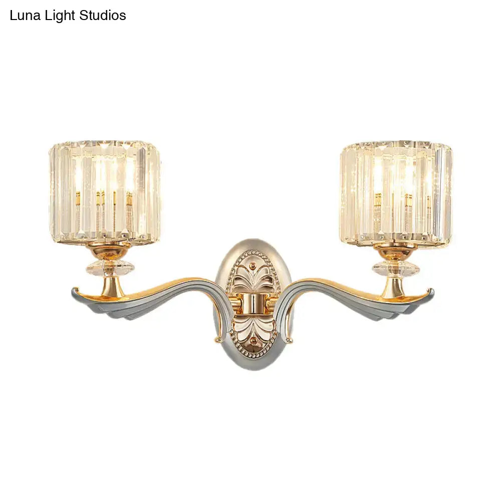 Elegant two-light flush mount wall sconce with gold-toned ornate metal frame and clear crystal shade for bedroom bulb base