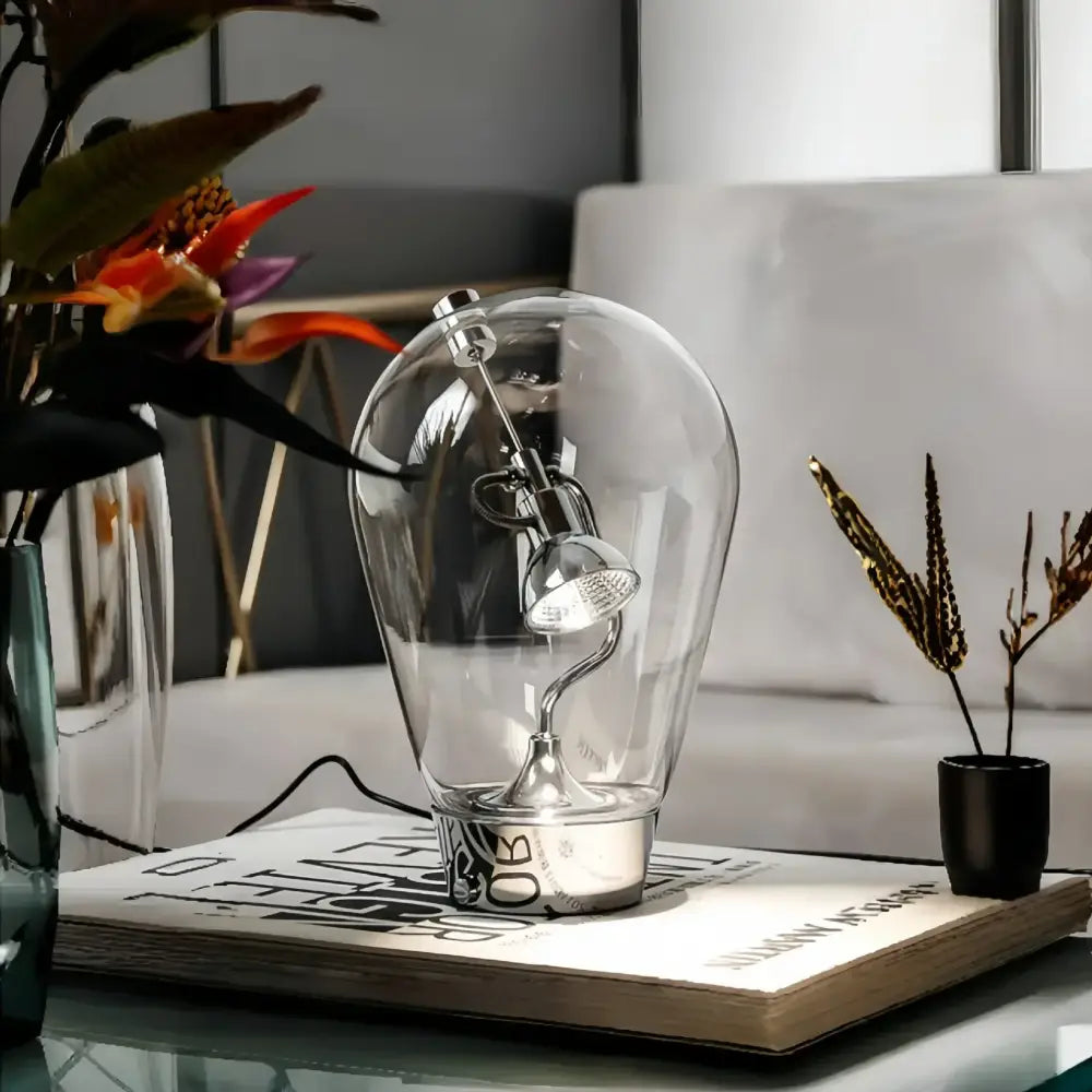 Modern silver glass desk lamp with adjustable spotlight in bulb-shaped enclosure ideal for decorbites glass desk use