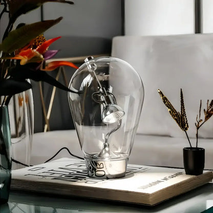 Modern silver glass desk lamp with adjustable spotlight in bulb-shaped enclosure ideal for decorbites glass desk use
