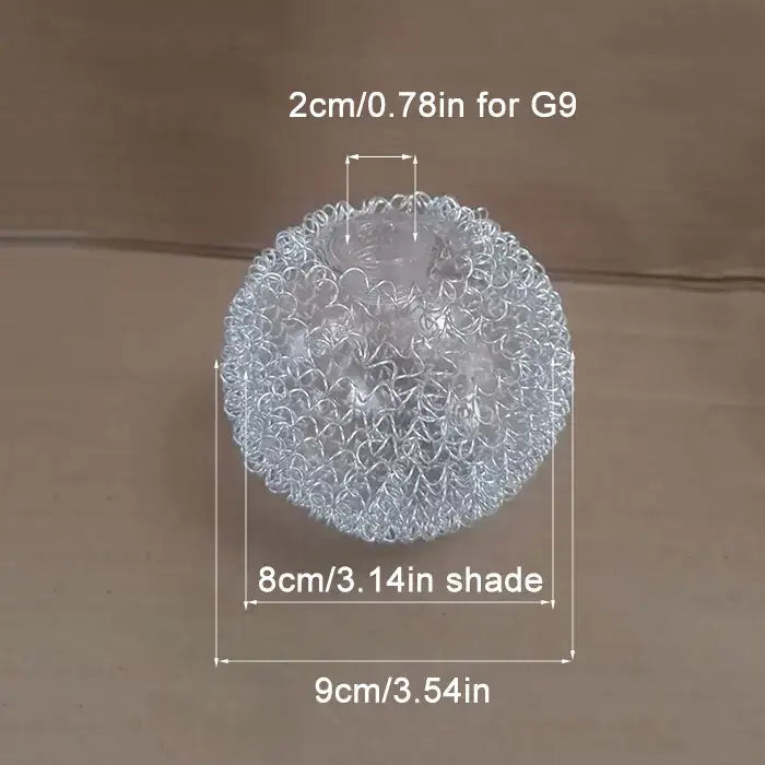 Silver metallic mesh ball with intricate, interwoven circular patterns.
