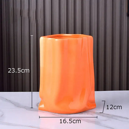 Modern silver pleated texture ceramic vase with vibrant orange glossy finish and sculpted sides for living room decorbites gold plated style