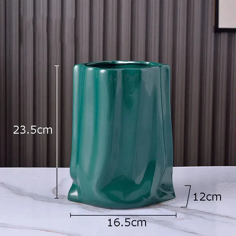 A glossy teal ceramic vase with pleated texture and a slightly flared base for modern living room decorbites gold plated style