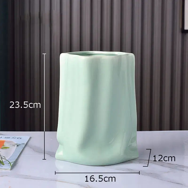 Modern silver pleated texture ceramic vase in light green with a sleek glossy finish for living room decorbites gold plated style