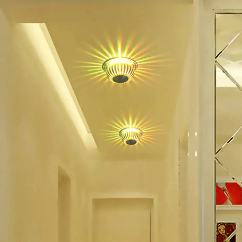 Two warm-toned direct wired silver starburst led sconces with metallic ribbed design for living room lighting