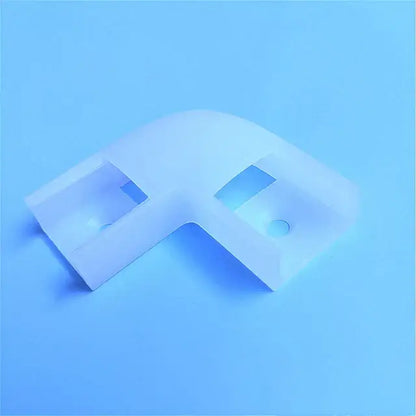 White translucent plastic l-shaped corner bracket with cutouts and holes for modern silver u-shape led bar strip light installation