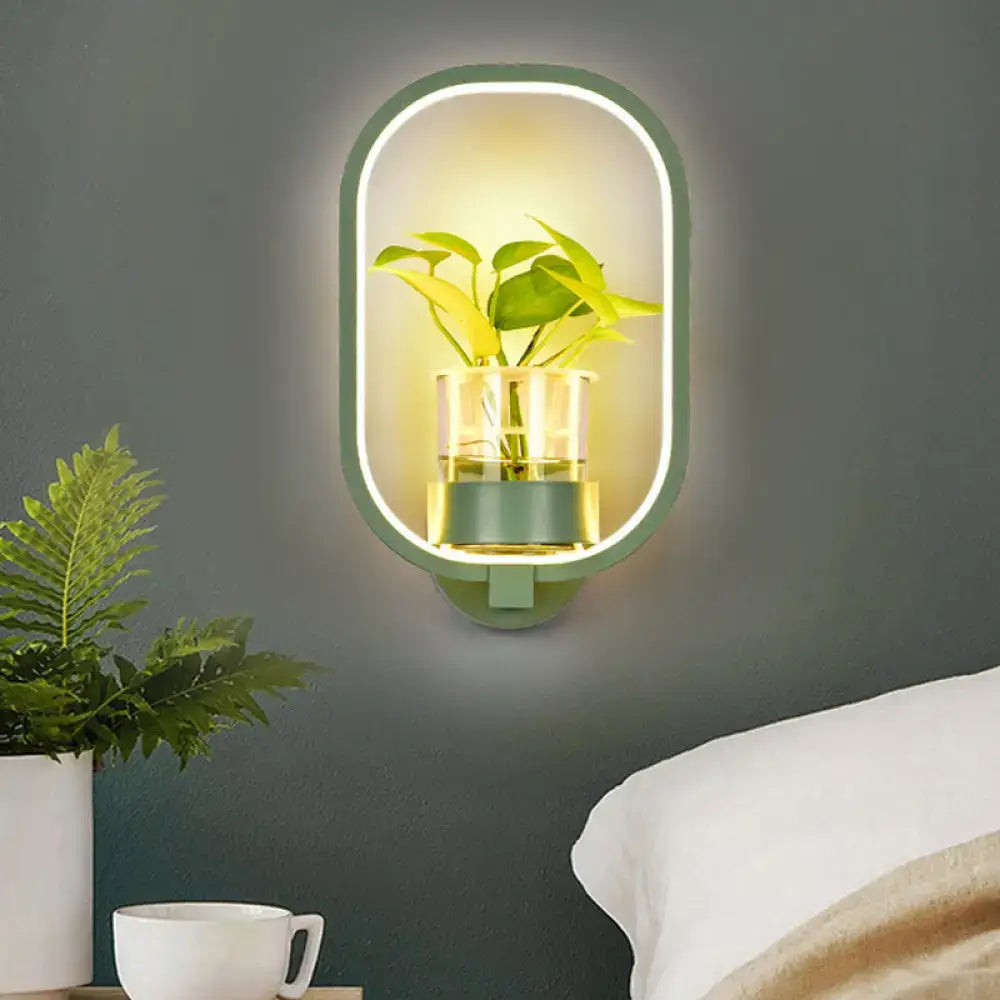 Modern oval wall light with green frame, glowing led ring, and integrated plant pot for 110v-120v bedroom use