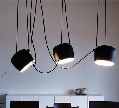 Modern simple aluminum snare chandelier with black matte pendant light, curved cord, and three bulb heads in a modern design