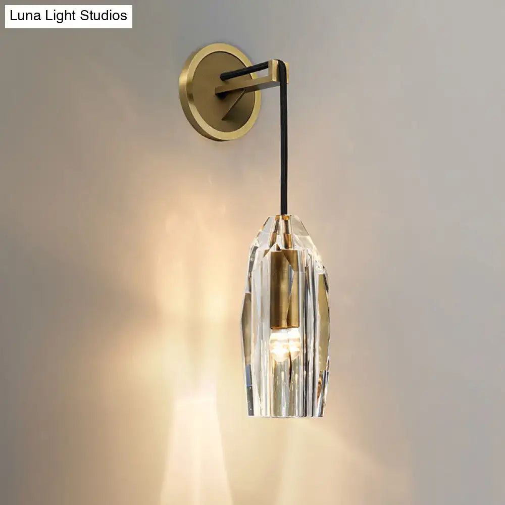 Modern single light brass wall sconce with clear crystal faceted shade and gold-toned metal base for bedroom lighting