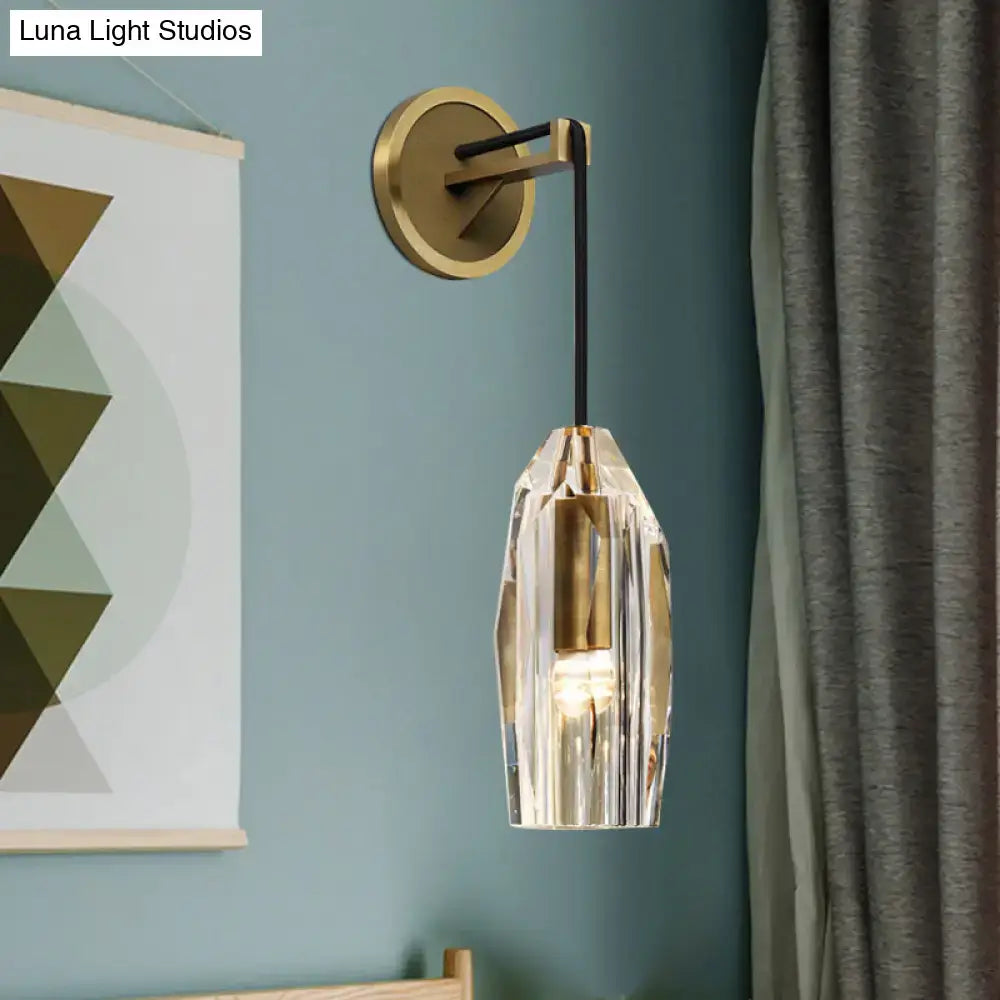 Modern single light brass wall sconce with clear crystal pendant and gold-toned metal base for bedroom lighting