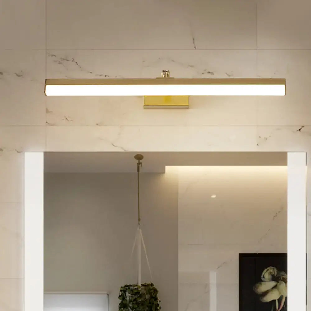 Modern sleek brass finish wall light fixture with gold rectangular led design mounted above bathroom vanity mirror