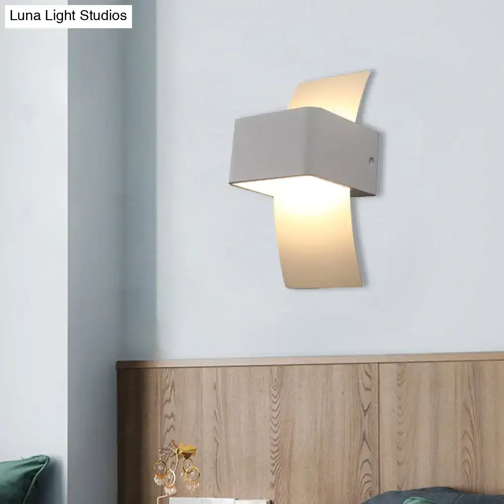 Modern gray wall sconce with sleek angular design and warm led light for bedroom ambient lighting