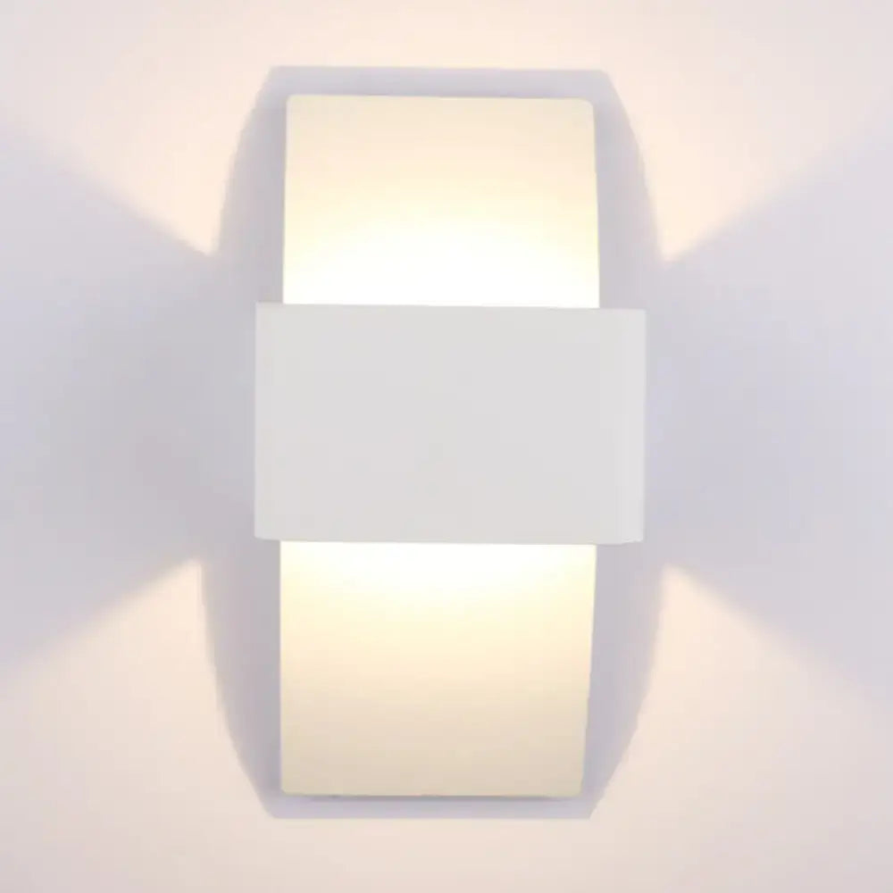 Modern sleek white rectangular wall sconce with minimalist design and warm diffused LED light for bedroom use