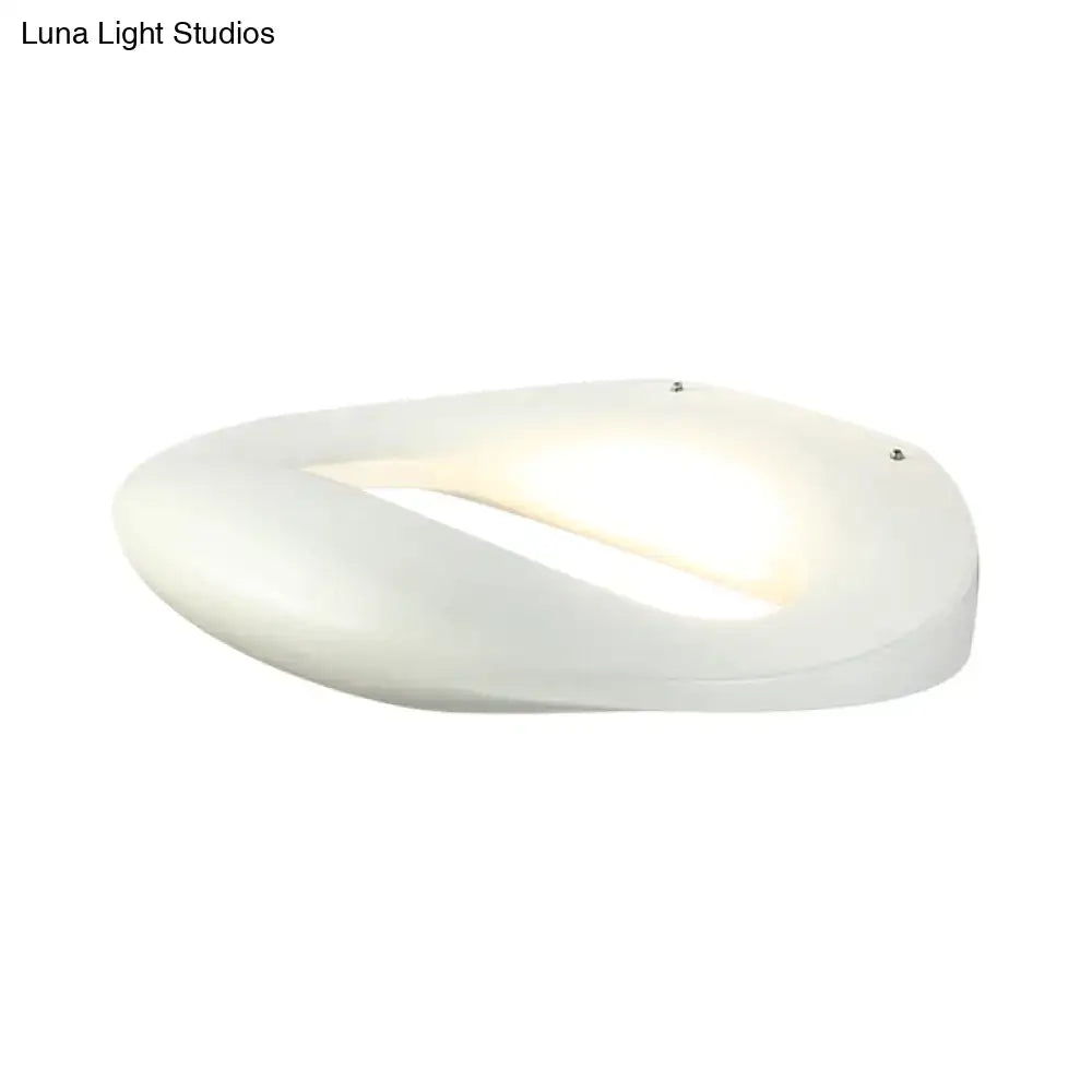 Modern smiling face black white wall lamp with a white oval-shaped frosted glass diffuser and integrated led lighting