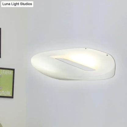 Modern smiling face black white wall lamp with a sleek white oval sconce and soft ambient led corridor lighting