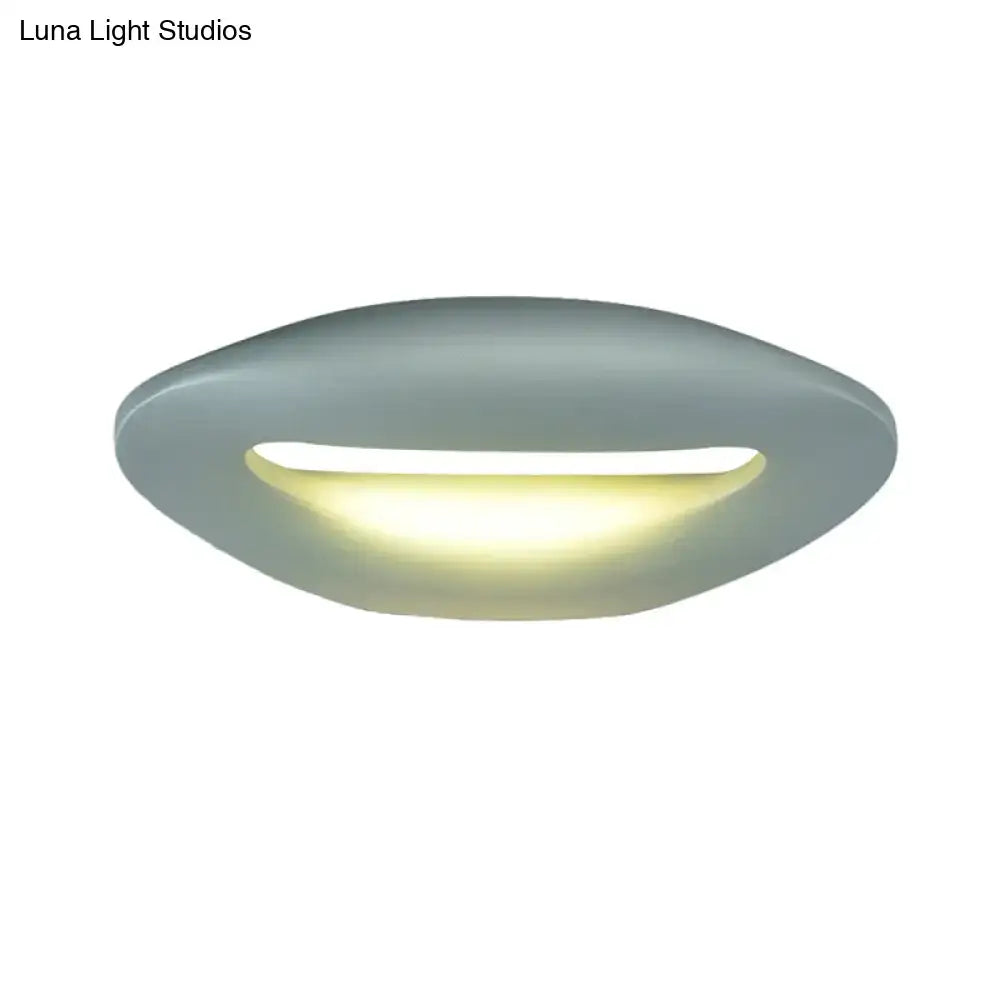 Modern smiling face black white led wall lamp with sleek matte gray oval ceiling light and warm yellow illumination