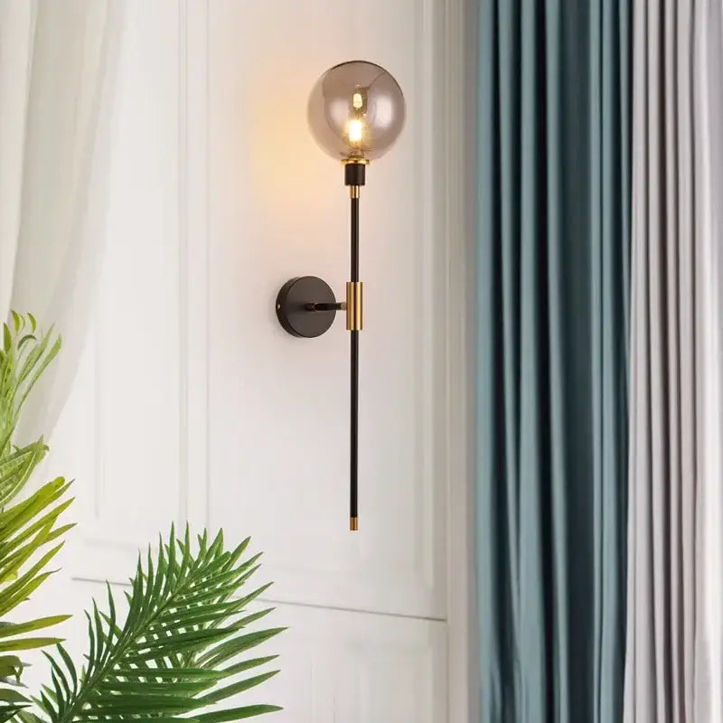 Modern smoked glass ball led wall light with black metal stem and brass accents for bedroom decorbites wall light