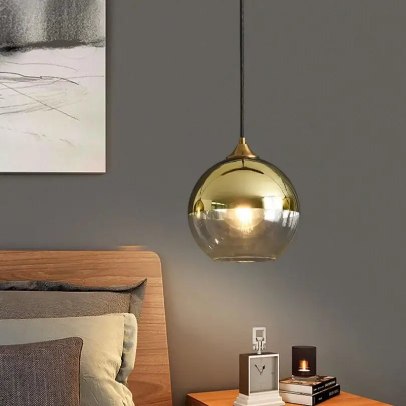 Gold-toned decorbites glass ball pendant lights with a sleek spherical design and black cord for kitchen and dining room decor