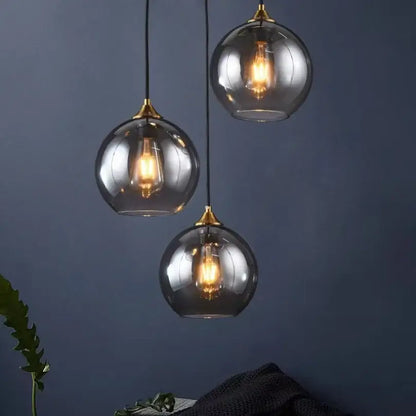 Modern smoked glass ball pendant lights triple set with brass accents and exposed filament bulbs for kitchen decorbites glass ball pendant