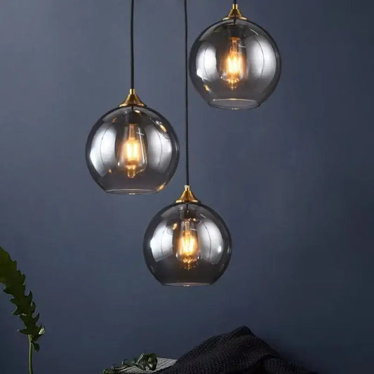 Modern smoked glass ball pendant lights triple set with brass accents and exposed filament bulbs for kitchen decorbites glass ball pendant