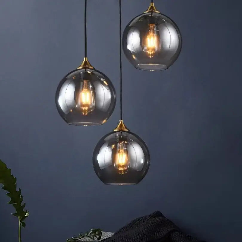 Modern smoked glass ball pendant lights triple set with brass accents and exposed filament bulbs for kitchen decorbites glass ball pendant