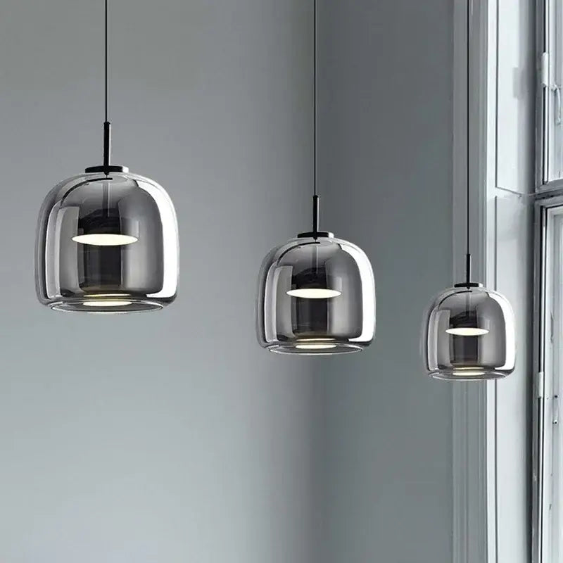 Modern smoked glass bowl chandelier with three translucent smoked glass domes and black metal fixtures for dining room