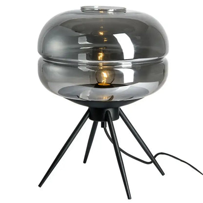 Modern smoked glass desk lamp with a sleek layered dome and black metal tripod base for decorbites glass desk use