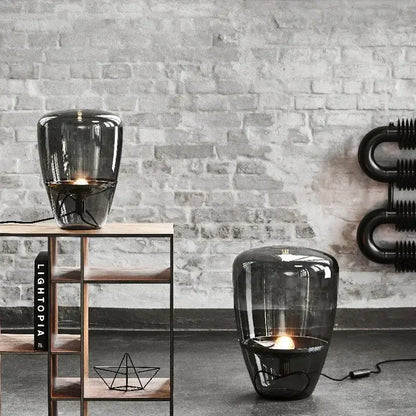 Modern smoked glass table lamp with visible filament bulb designed as a sleek glass table lamp for bedroom use