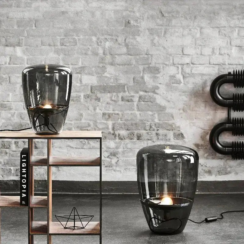 Modern smoked glass table lamp with visible filament bulb designed as a sleek glass table lamp for bedroom use