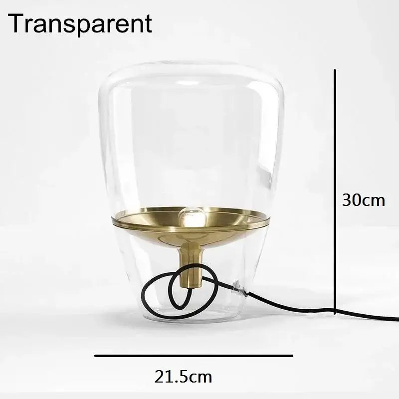 Modern smoked glass table lamp with brass base and cord for bedroom use featuring a transparent balloon glass table design