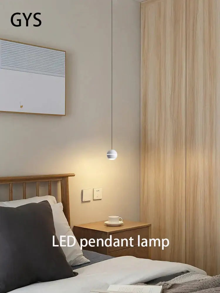 Minimalist spherical gold led pendant lamp with sleek metallic finish hanging above bedside table decorbites gold led