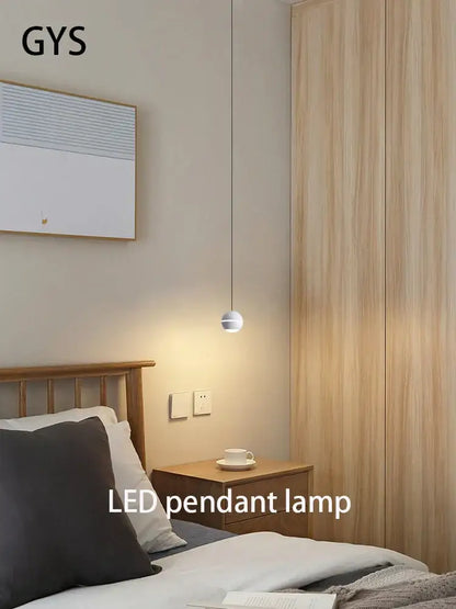 Minimalist spherical gold led pendant lamp with sleek metallic finish hanging above bedside table decorbites gold led