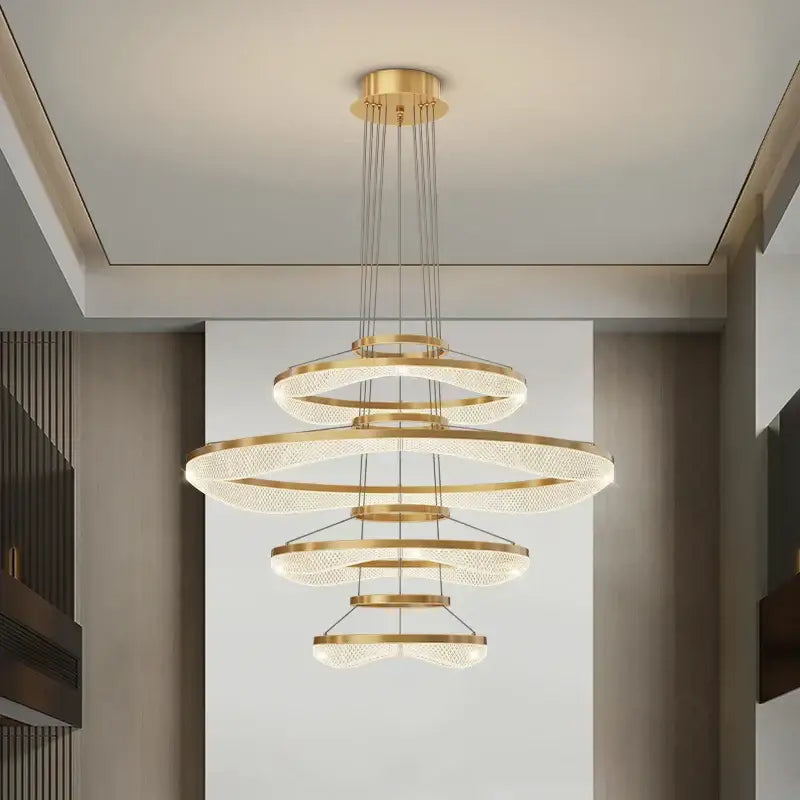 Modern spiral acrylic ring pendant light fixture with gold-toned concentric rings and crystal elements for living room