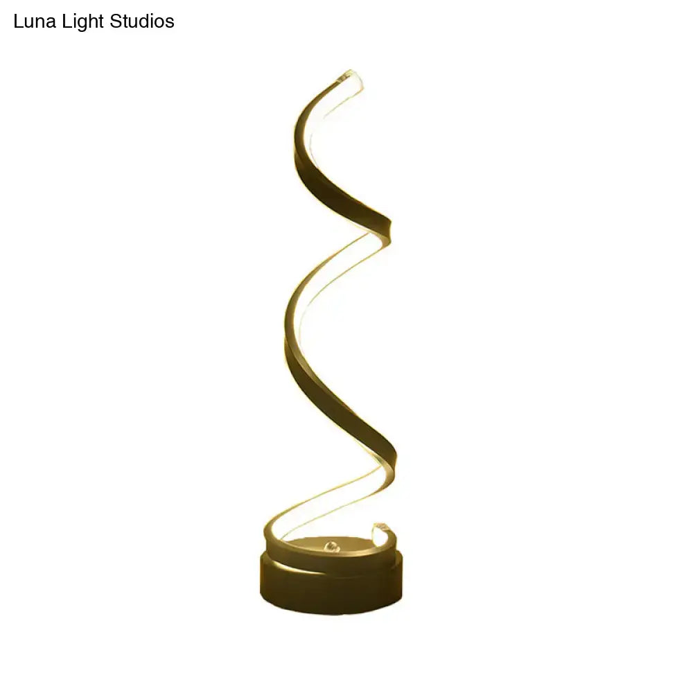 A modern black white gold floor lamp with a spiraling design and warm golden led light for bedroom task lighting