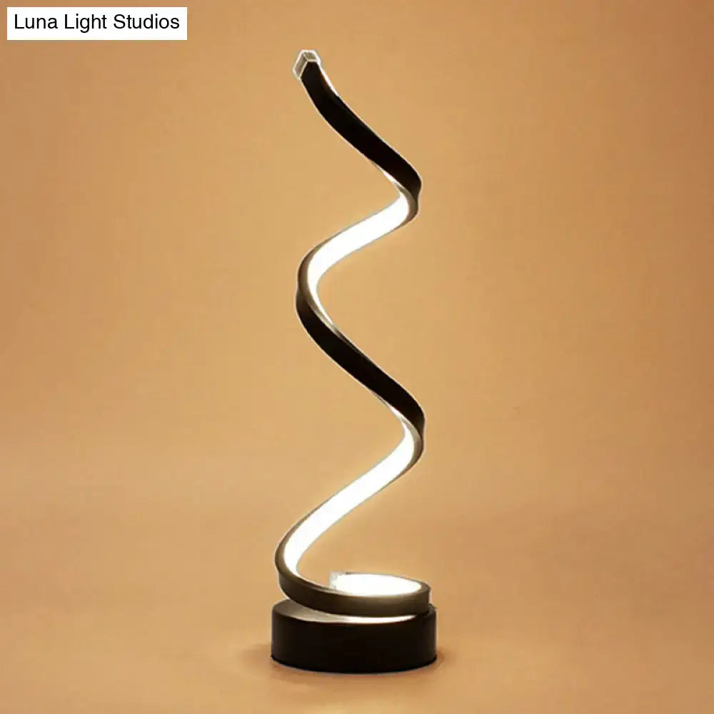 A sleek black white gold led table lamp with a spiral light type design ideal for bedroom task lighting