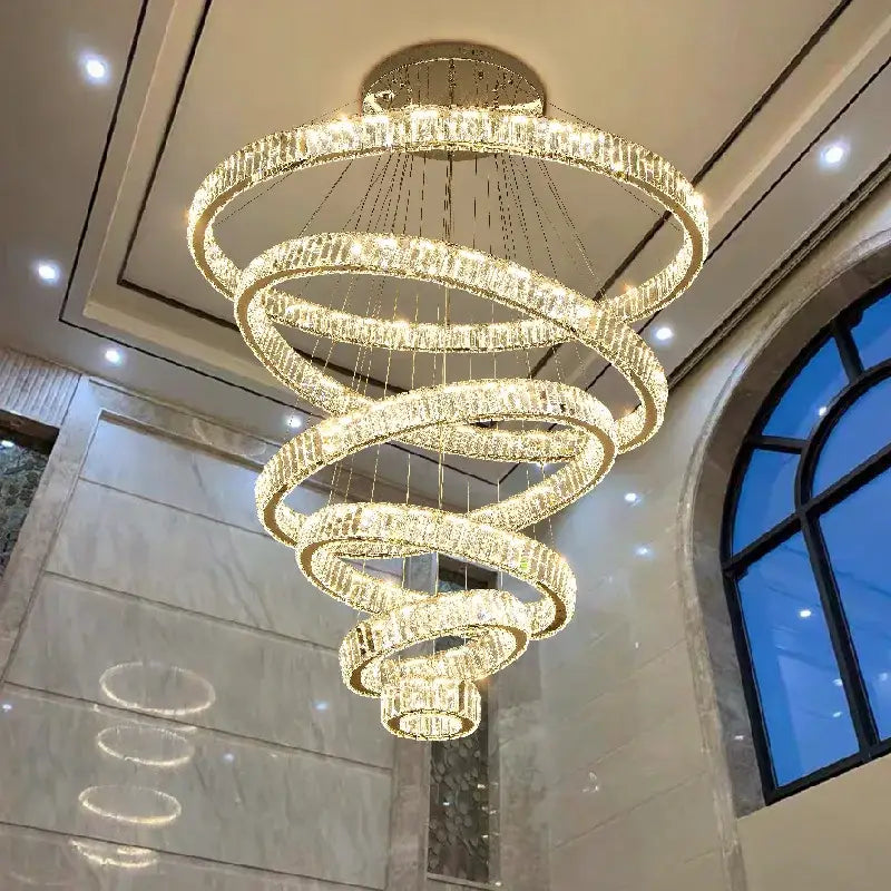 Modern spiral crystal circle led chandelier featuring multi-tiered cascading rings with warm glowing lights for staircase decorbites crystal circle
