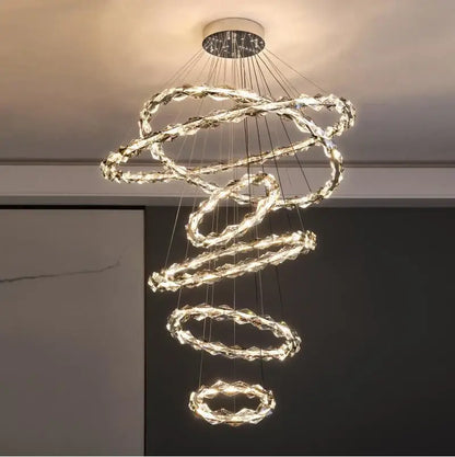 A modern spiral decorbites crystal chandelier with glowing LED rings and a sleek metallic ceiling mount for living rooms