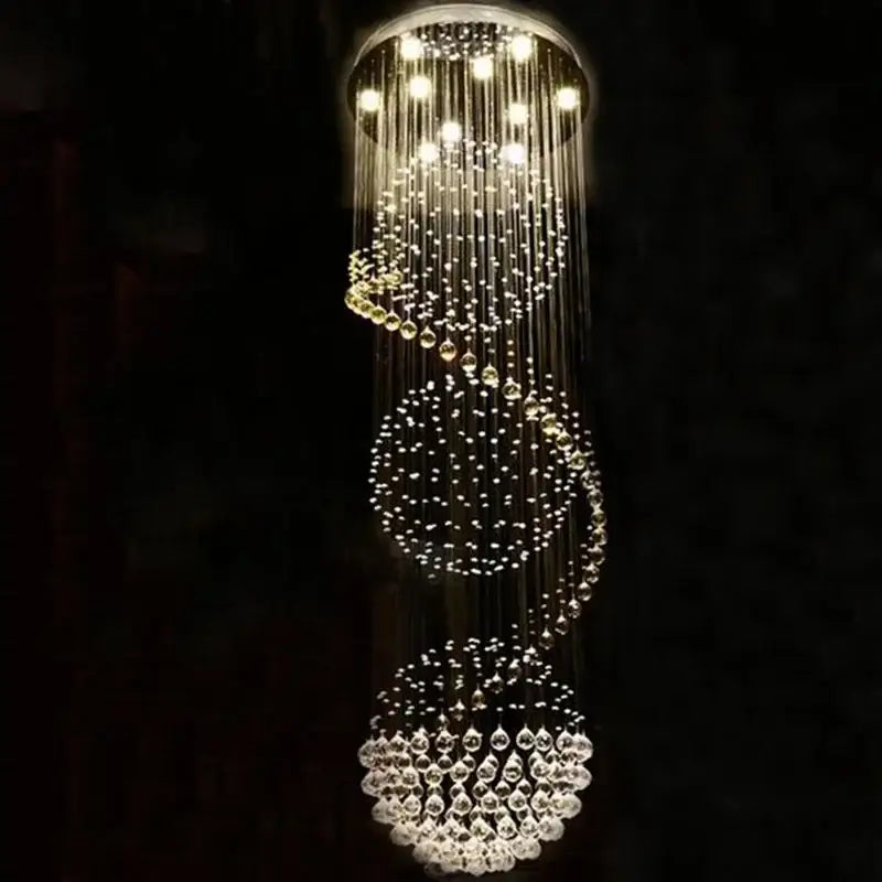 A modern decorbites crystal led chandelier with cascading clear glass beads in spiral tiers for dining room lighting