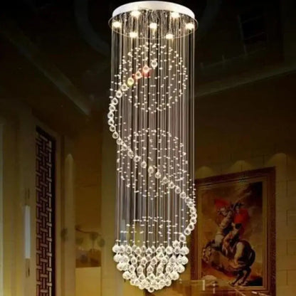 A modern decorbites crystal led chandelier with a sleek white top and spiral clear faceted crystal strands for dining rooms