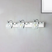 Modern stainless steel wall light with three chrome-finished textured glass globes providing warm white light