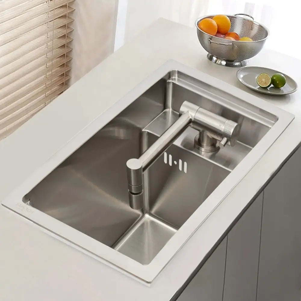 Modern stainless steel single bowl undermount kitchen sink with sleek design and integrated pull-down faucet