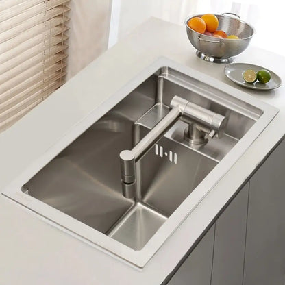 Modern stainless steel single bowl undermount kitchen sink with sleek design and integrated pull-down faucet