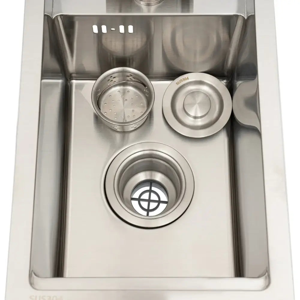 Modern stainless steel single bowl kitchen sink with central drain, perforated strainer basket, and matching stopper